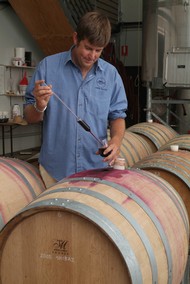 Swan Valley winemaker pulling wine sample out of aged oak barrel